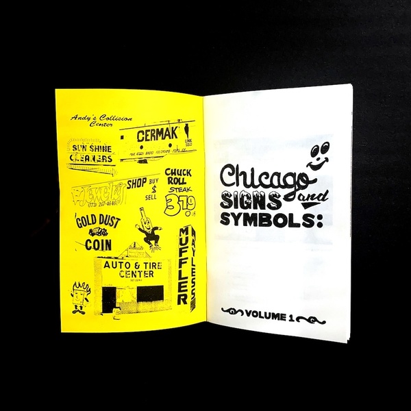  An open book with one white page and one yellow page. There is screen prints on each side of different Chicago signs and symbols. The white page reads: Chicago Signs and Symbols: Volume 1 