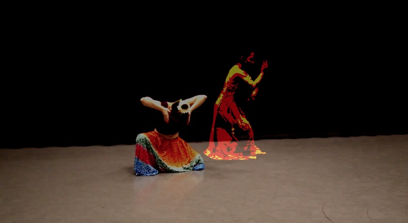  woman dances in colofrul skirt as rendered image moves to her right 