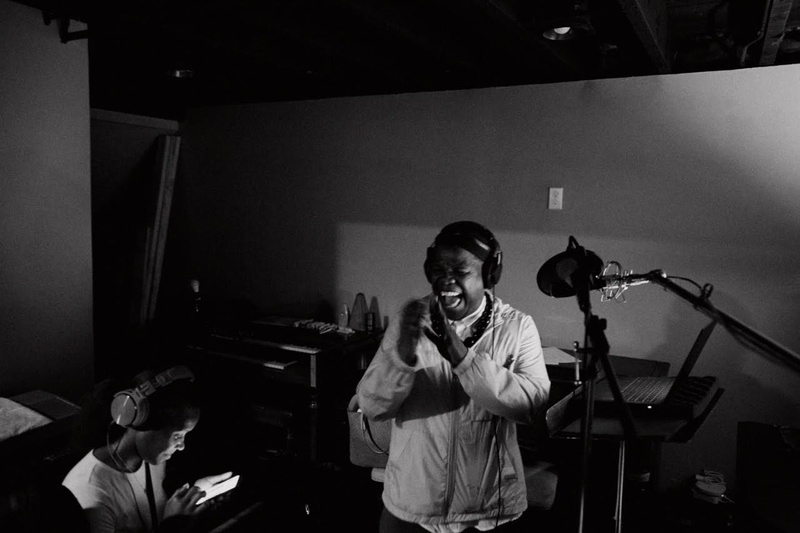  black man in an anorak inside a recording studio 
