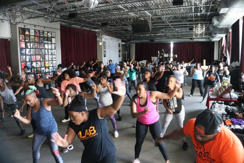  group of people in large space are mid dance 