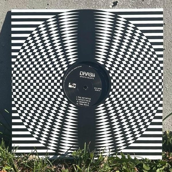  A black and white patterned vinyl record sleeve. The record reads Drasii and has an eyeball on the center. 