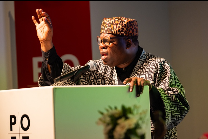  black male poet in leopard print hat and striped kimono jacket 