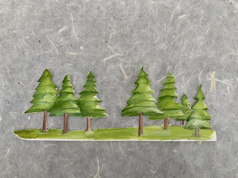  A cut-out of seven watercolor trees against a textured paper. 