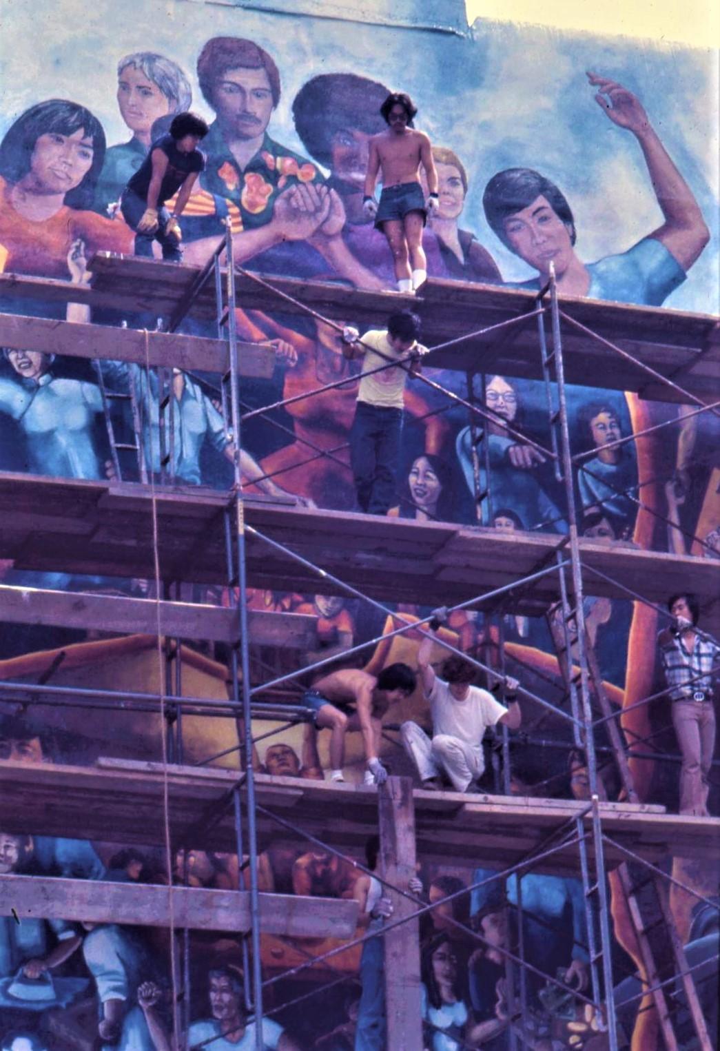 1974 CitiArts mural. Taking down the scaffold. Arlan Huang standing on the top tier with Alan Okada. 
